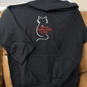 Black hoodie with cat-themed embroidery design.