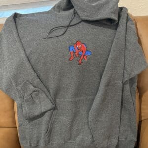 Gray hoodie with Spider-Man logo design.