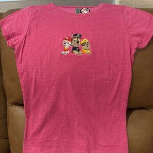 Pink shirt with cartoon dog characters design.