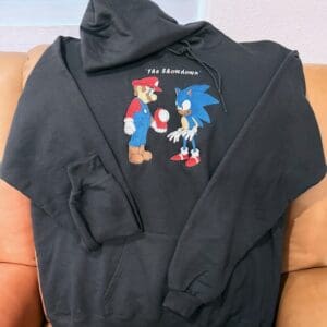 Black hoodie with cartoon characters and text.