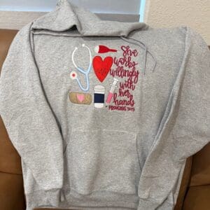 Gray hoodie with nursing-themed embroidery design.