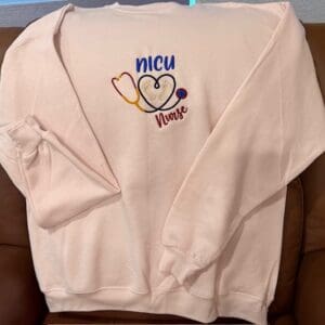 Sweatshirt with NICU Nurse embroidery design.