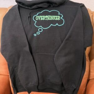 Black hoodie with "Overthinker" thought bubble.