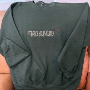 Dark green sweatshirt with motivational text.
