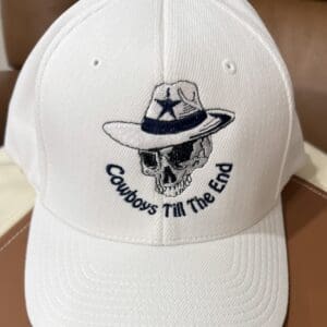 White cap with skull and cowboy hat.