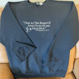 Black sweatshirt with biblical quote design.
