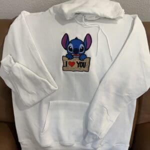 White hoodie with cartoon character and love message.