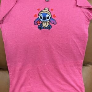 Pink T-shirt with cute cartoon character design.