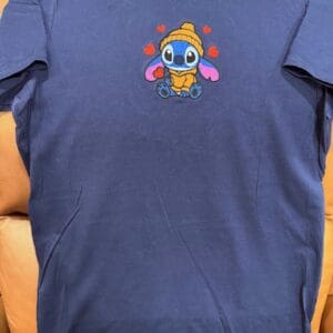 Blue shirt with cute character and hearts.