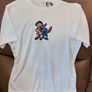 White shirt with cartoon characters embroidered.