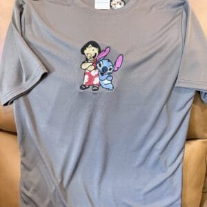 Gray t-shirt with cartoon characters embroidered.