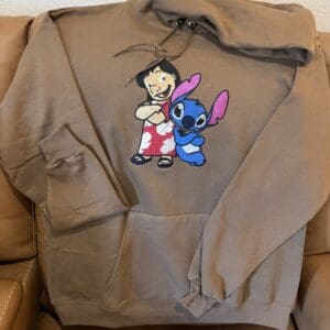 Brown hoodie with cartoon characters design.