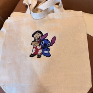 Tote bag with cartoon characters embroidered.
